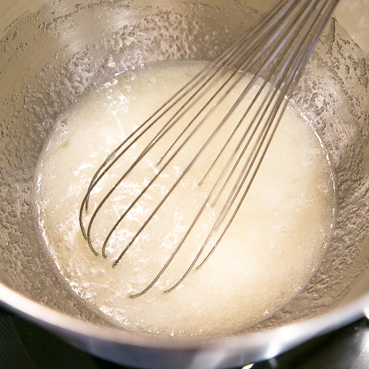 This old-fashioned 7 minute frosting recipe is light, delicious, and easy to make. A pure white frosting that's perfect for a variety of delicious desserts. | livforcake.com Egg and sugar mixture before cooking.