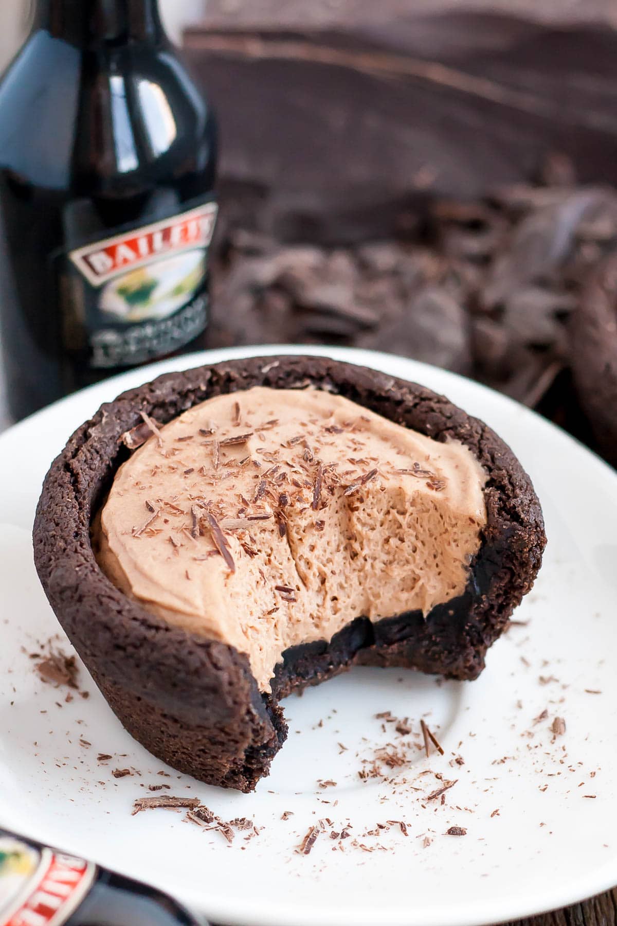 Chocolate cookie cups filled with a chocolate Baileys cheesecake. The perfect bite-sized indulgence! | livforcake.com Fluffy Baileys cheesecake chocolate cookie cups.
