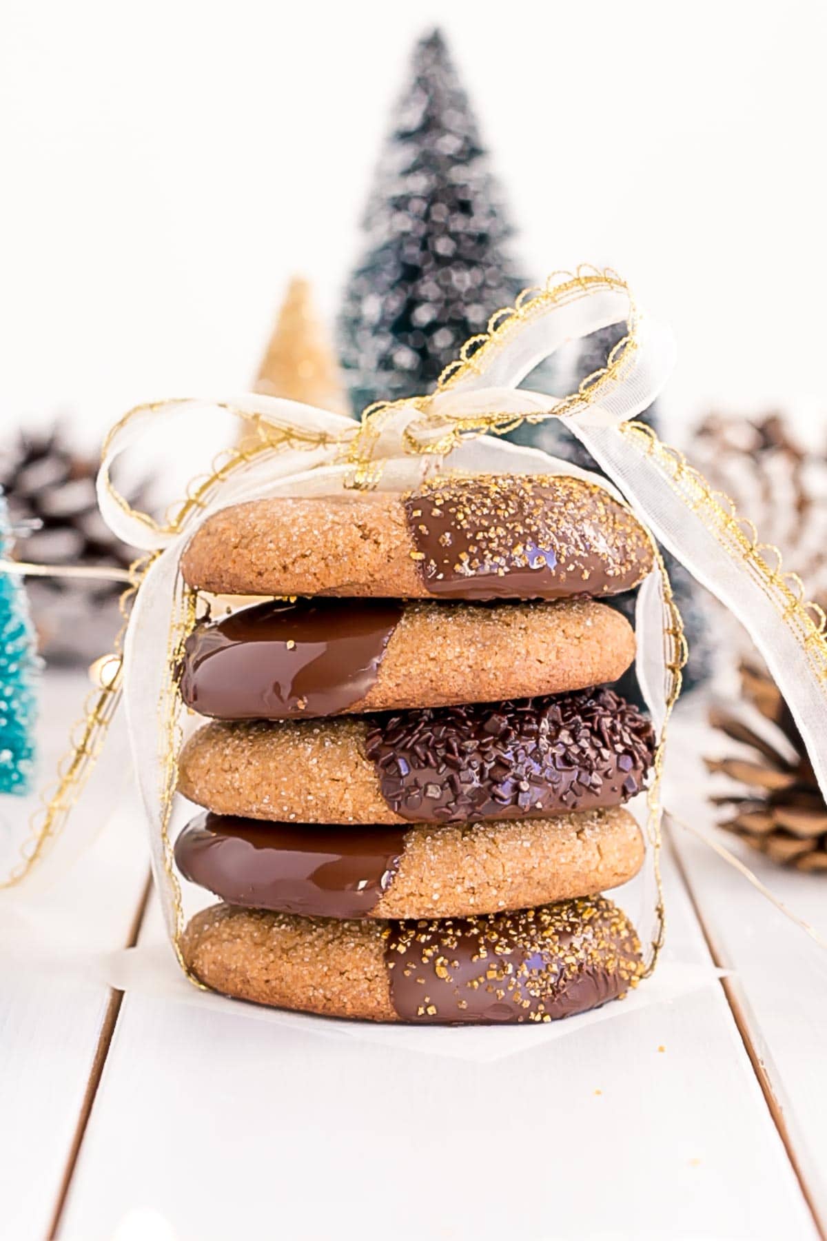 These Chocolate Dipped Gingerbread Cookies are the perfect treat for the holiday season! Chewy ginger spiced cookies dipped in dark chocolate. | livforcake.com Stack of Chocolate Dipped Gingerbread Cookies