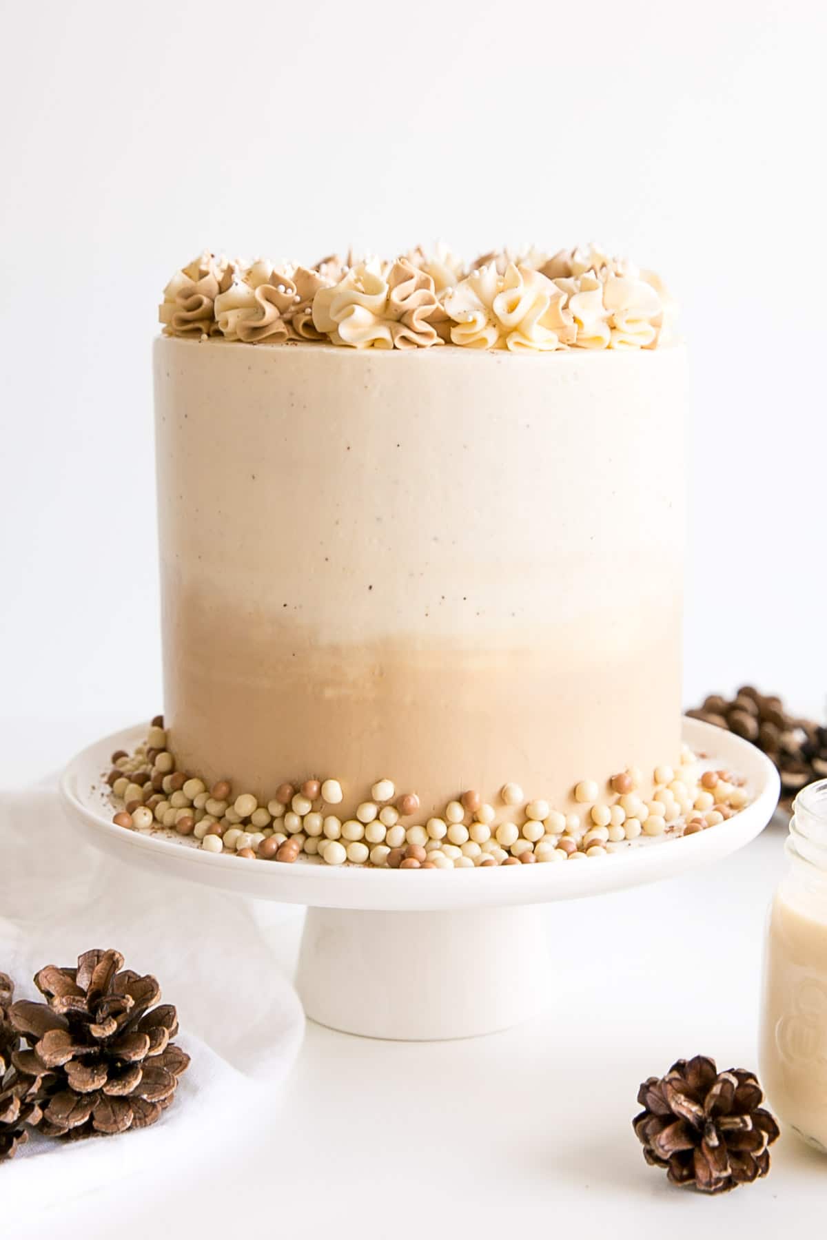 Eggnog Latte Cake! Transform a favourite holiday beverage into a decadent dessert with this Eggnog Latte Cake! Eggnog infused cake layers paired with eggnog and espresso buttercreams. | livforcake.com Eggnogg cake with an ombre buttercream frosting and rosettes.