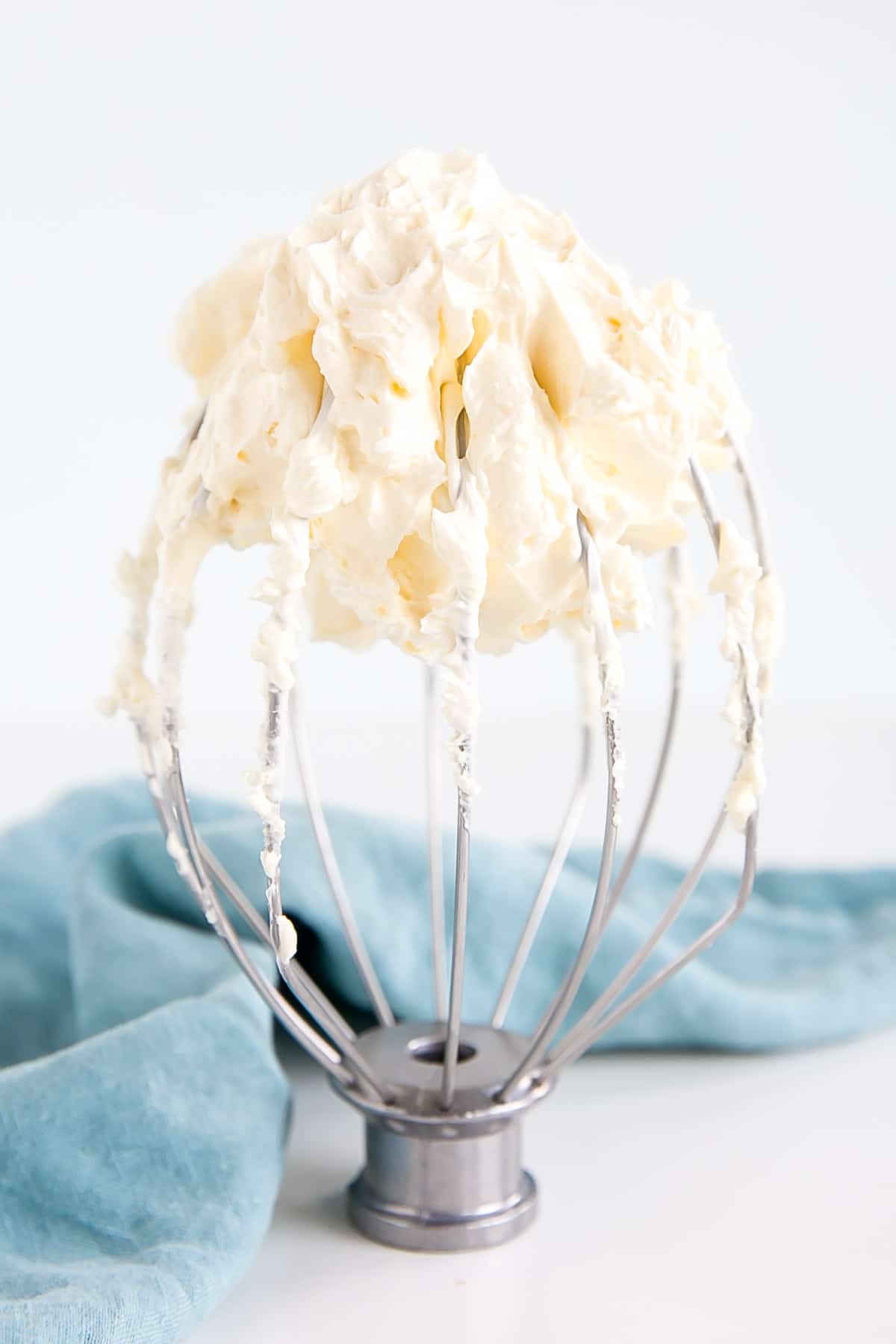 This custard-based German buttercream is made with just a few simple ingredients. Perfect for those who like a rich and silky frosting that isn't too sweet! | livforcake.com German buttercream on a whisk attachment.