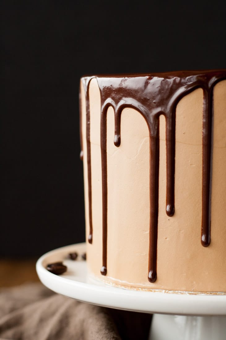 Mocha Cake! A rich dark chocolate cake with a silky mocha swiss meringue buttercream. | livforcake.com Close up of drip on a Mocha Cake