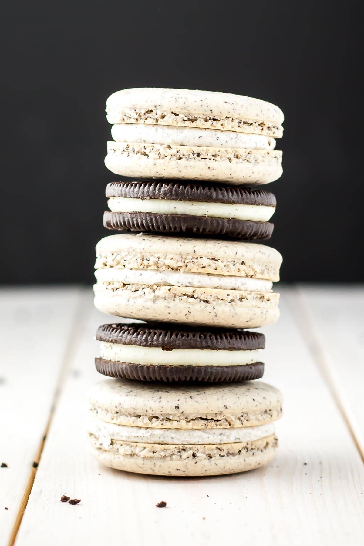 Oreo Macarons! Turn your favourite store-bought classics into something more decadent with these delicate Oreo macarons. | livforcake.com Alternating stack of macarons with Oreo cookies