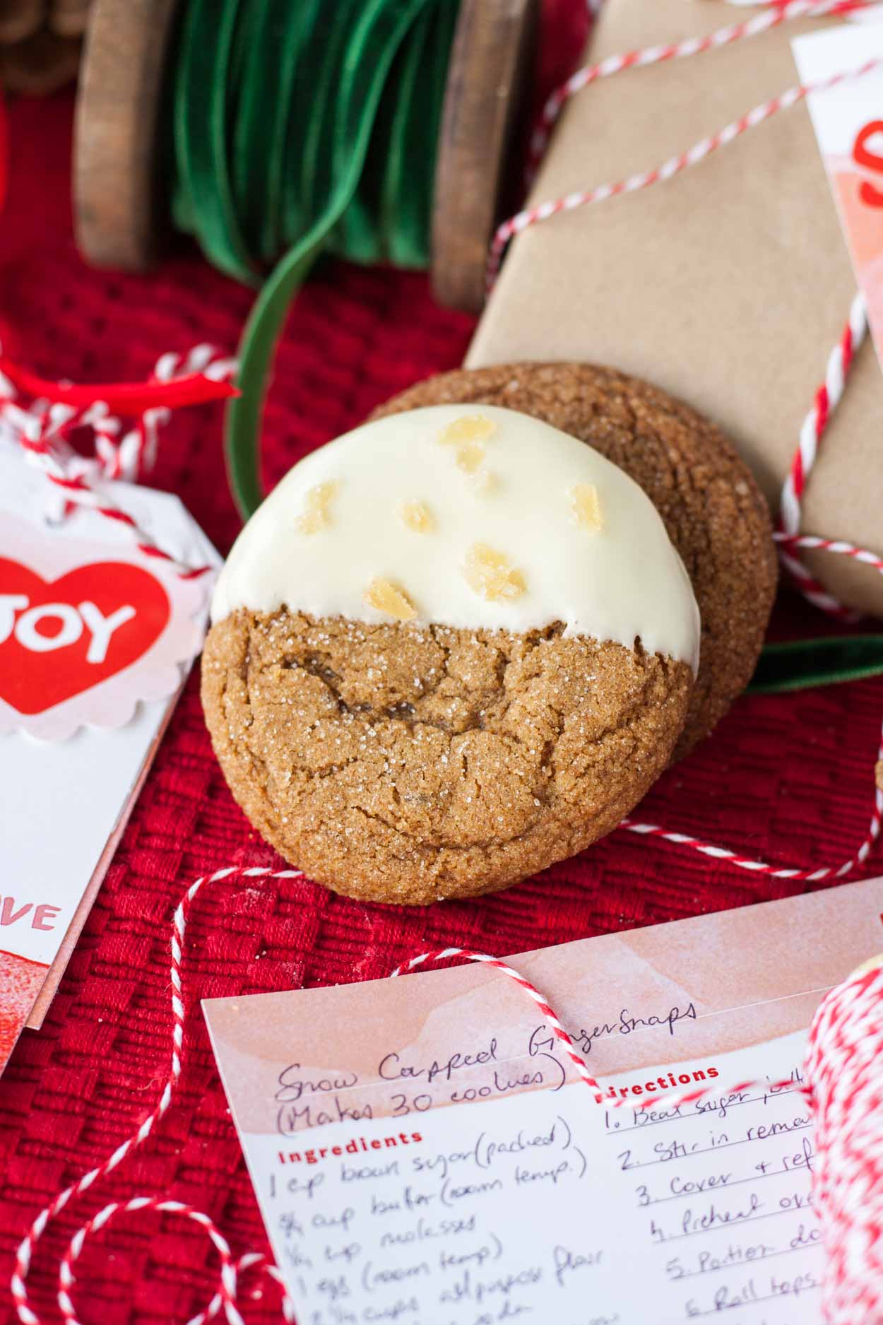 These Snow Capped Gingersnaps are the perfect Christmas cookies! Chewy gingerbread cookies dipped in white chocolate and topped with crystallized ginger. | livforcake.com white chocolate dipped gingersnaps